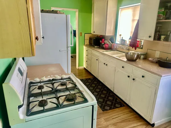 a backyard of a house with lots of green space and fountain in the back