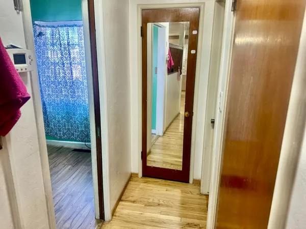 a bathroom with a sink mirror and a shower
