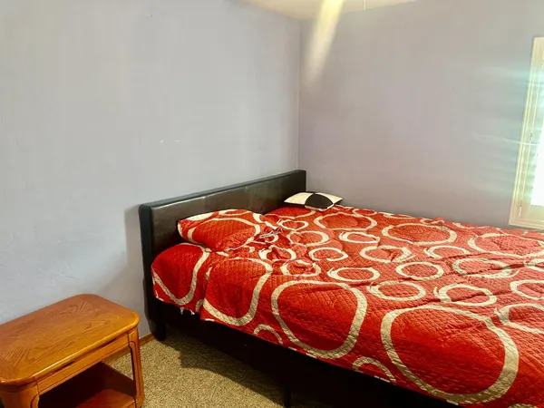a kitchen with refrigerator and chairs