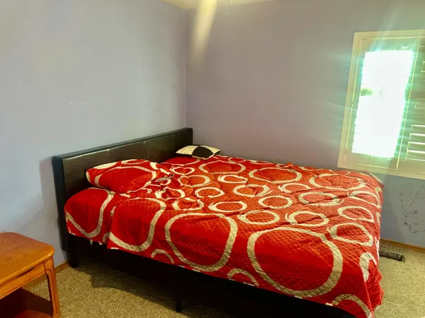 a living room with furniture window and a wooden floor