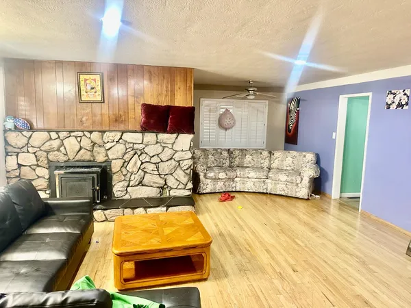 a kitchen with stainless steel appliances granite countertop a dining table chairs and granite counter tops