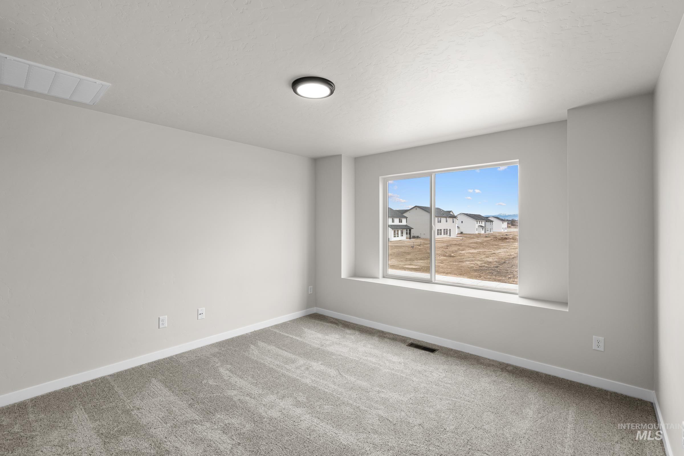 503 Hamlow Avenue Middleton, ID 83644 - Photo 11 of 21 Empty room featuring light colored carpet and baseboards