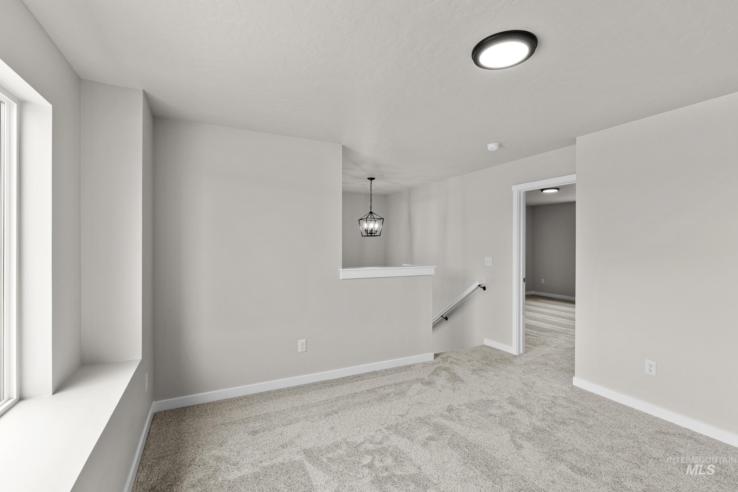 503 Hamlow Avenue Middleton, ID 83644 - Photo 12 of 21 Empty room featuring light colored carpet and baseboards