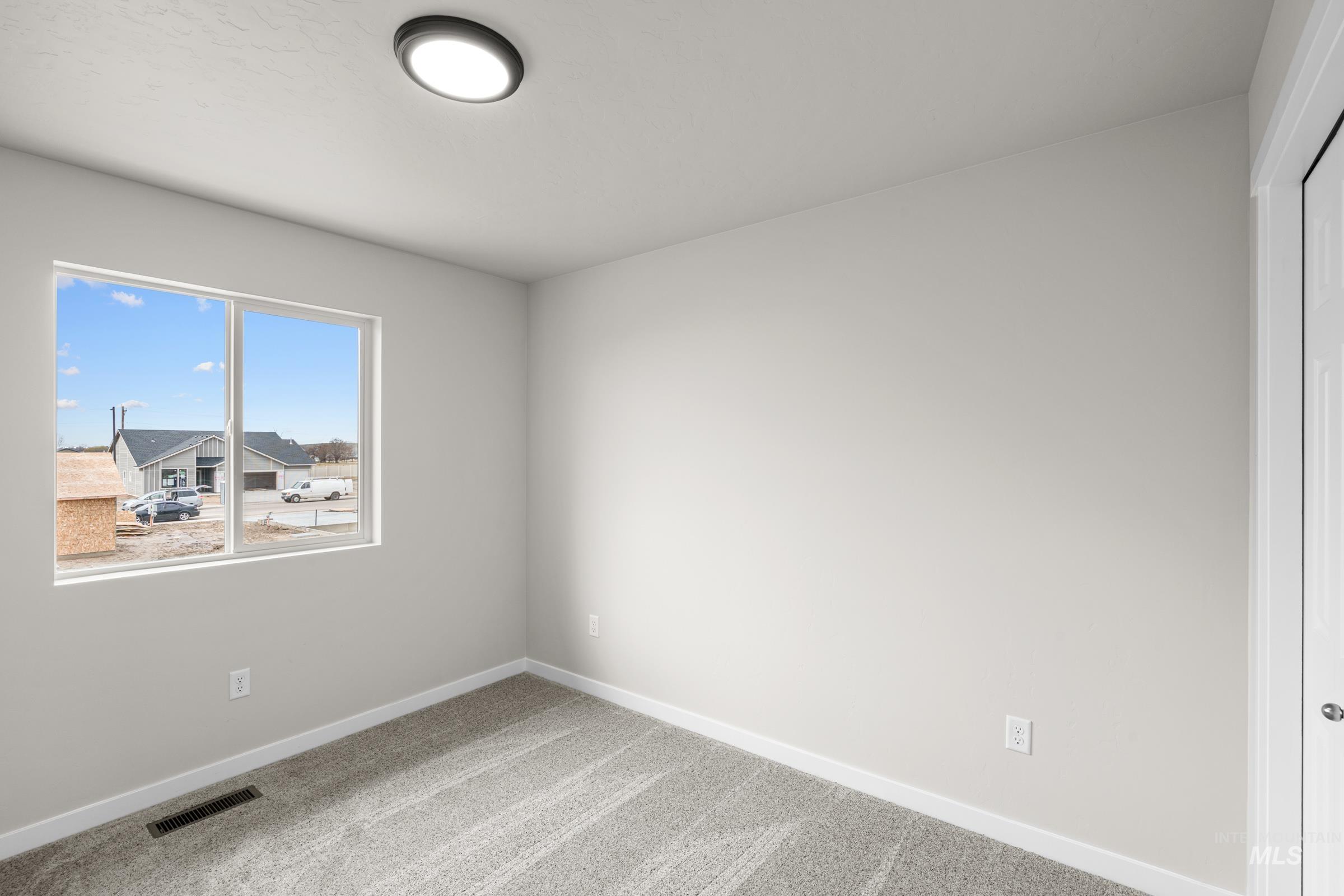 503 Hamlow Avenue Middleton, ID 83644 - Photo 15 of 21 Empty room featuring baseboards and light carpet