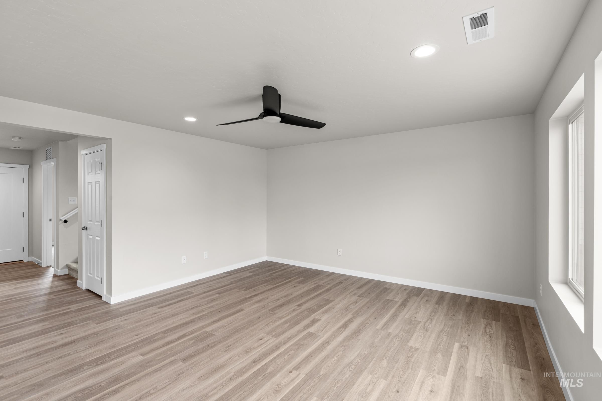503 Hamlow Avenue Middleton, ID 83644 - Photo 9 of 21 Spare room with a ceiling fan, light wood-style floors, and recessed lighting