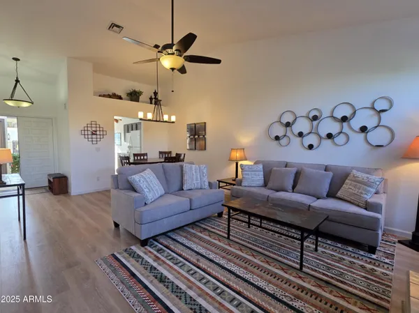 a view of a dining room with furniture and wooden floor