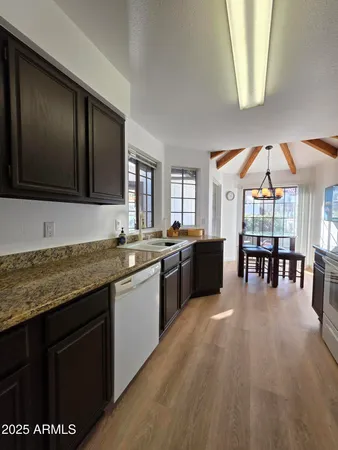 a kitchen with stainless steel appliances granite countertop a stove and a sink