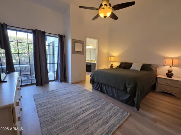 a bedroom with a bed and a chandelier