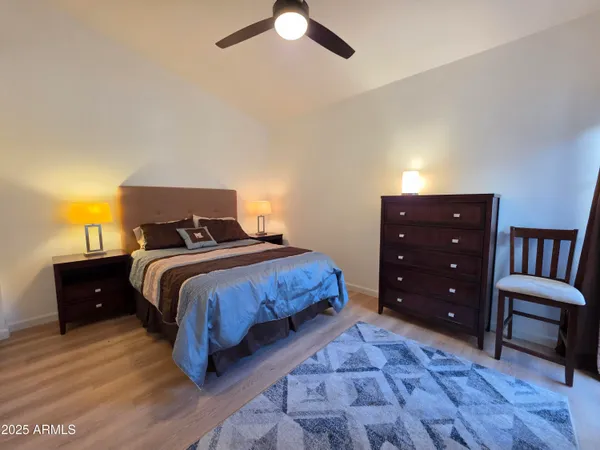 a bedroom with a bed and a television