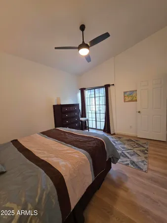 a bathroom with a granite countertop toilet sink and mirror