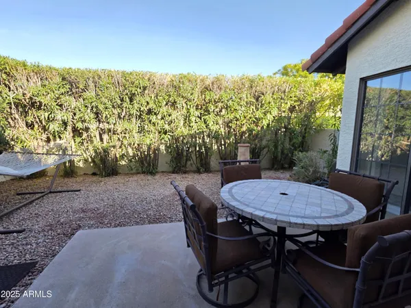 a table and chairs sitting in front of a house