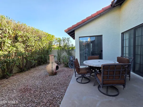 a view of backyard with seating space and trees