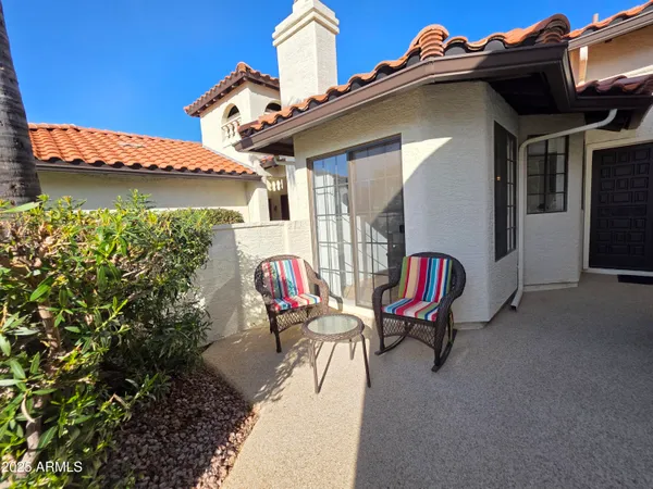 a backyard of a house with outdoor seating