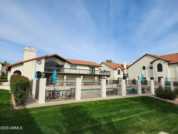 a view of swimming pool with outdoor seating and a garden