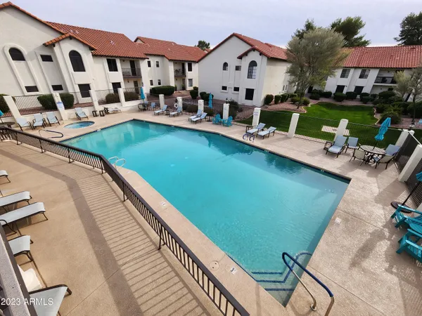 a view of swimming pool with outdoor seating and a garden