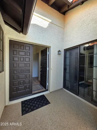 a view of a dining room and livingroom with furniture wooden floor a rug a potted plant and a chandelier