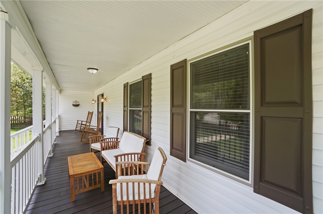 1208 Jarva Lane Springboro, OH 45066 - Photo 10 of 75 Relax on this spacious covered porch, perfect for enjoying peaceful outdoor moments.