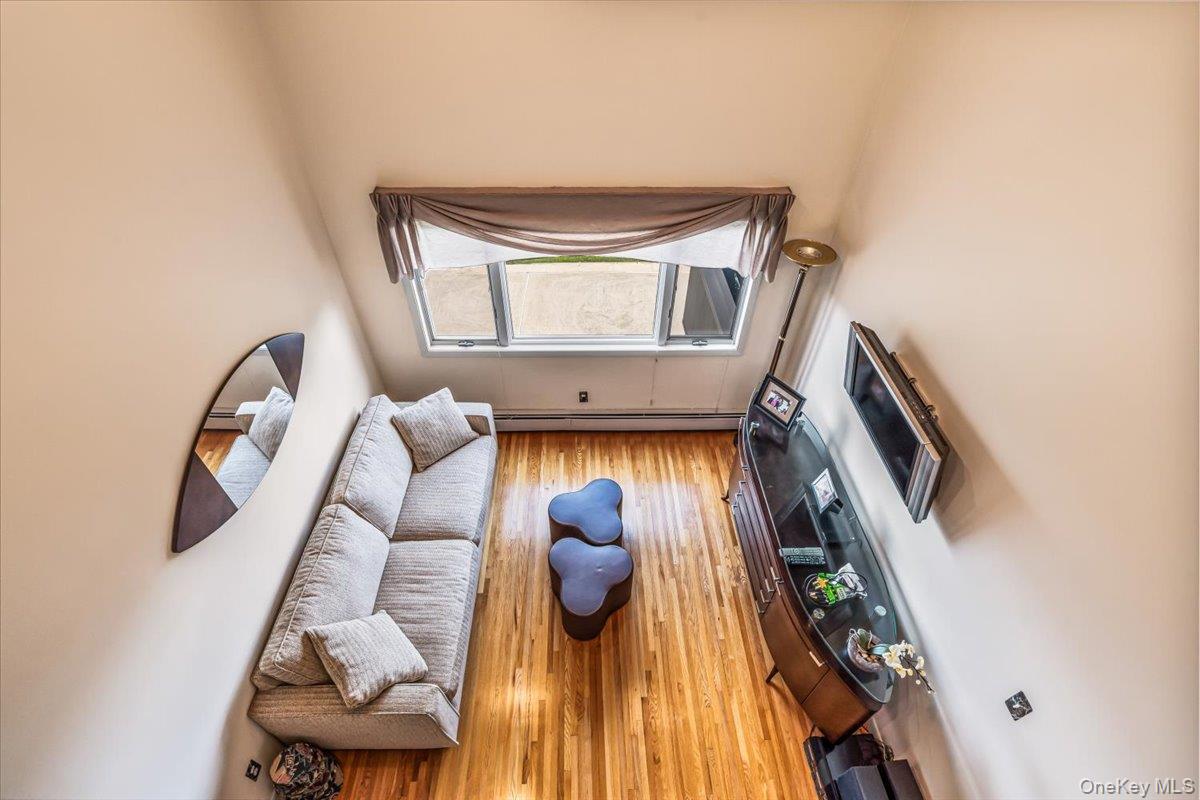 154-43 Riverside Drive Queens, NY 11357 - Photo 11 of 41 a view of staircase with wooden floor and a rug