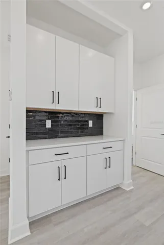 a kitchen with white cabinets and white appliances