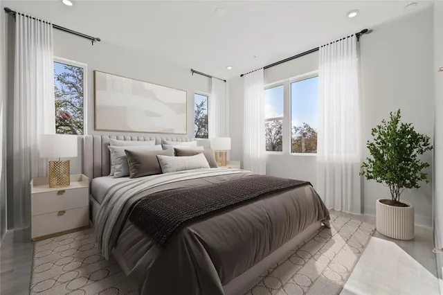 a bedroom with a bed and a potted plant