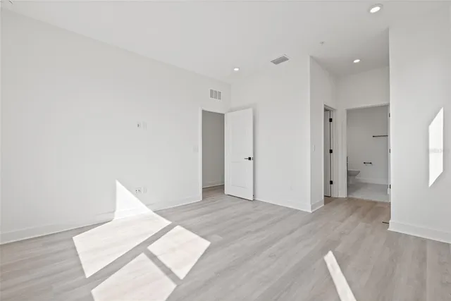 a view of an empty room and wooden floor