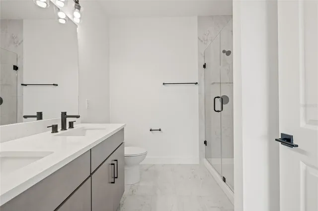 a bathroom with a sink toilet and shower