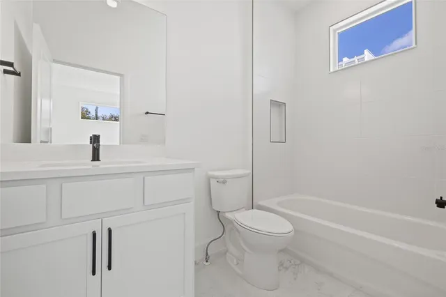 a bathroom with a toilet sink and shower