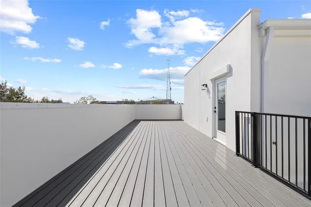 a view of a balcony with wooden floor