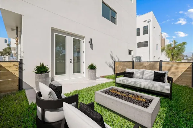 a living room with furniture and a potted plant