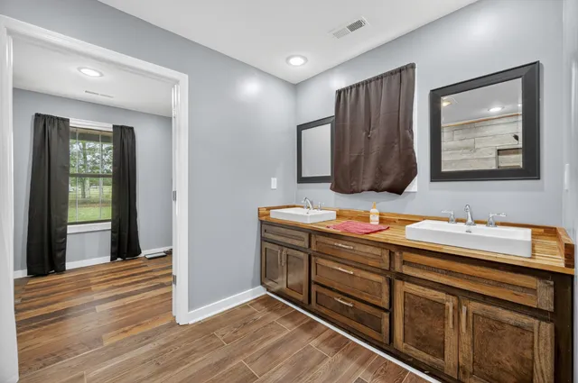 a bathroom with a sink vanity and mirror