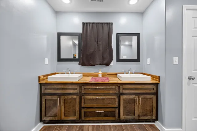 a bathroom with a sink a vanity and mirror