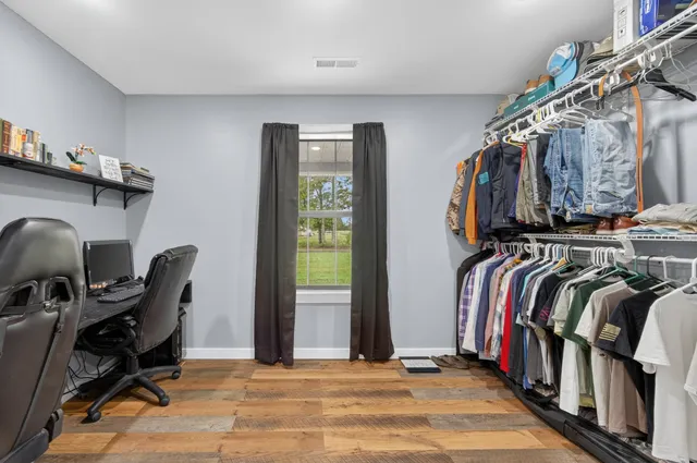 a view of walk in closet with clothes and shoes