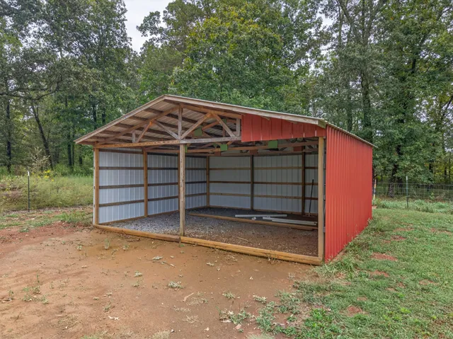a view of a small house with a yard