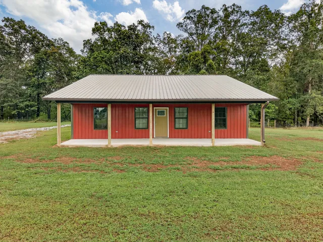 a front view of a house with a yard porch and outdoor seating