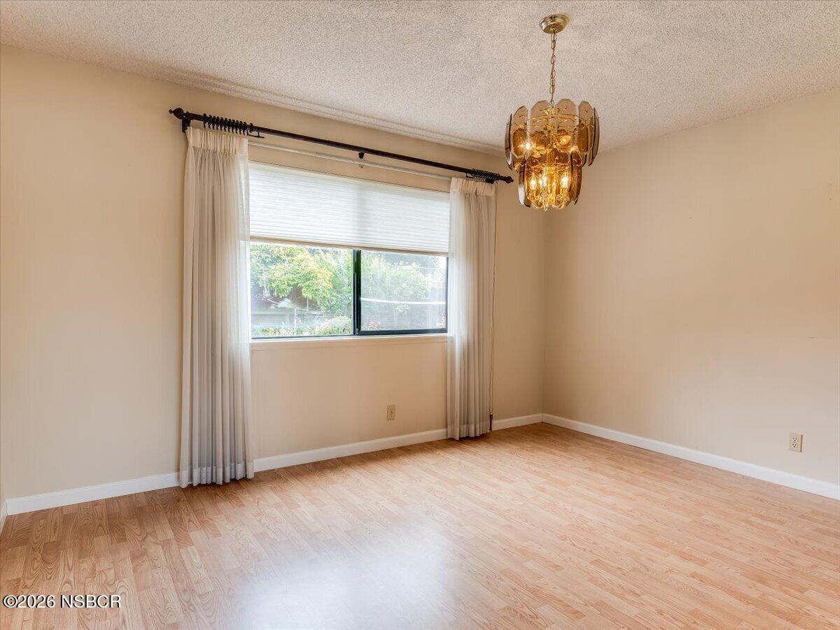 360 Tallyho Road Santa Maria, CA 93455 - Photo 14 of 72 a view of a room with a large window ceiling fan and wooden floor
