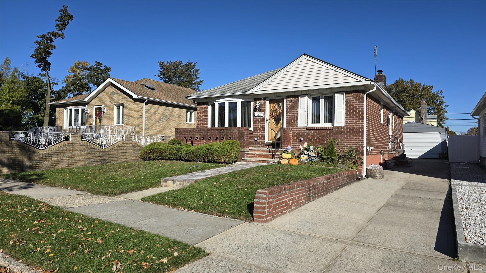 a front view of a house with a garden and plants