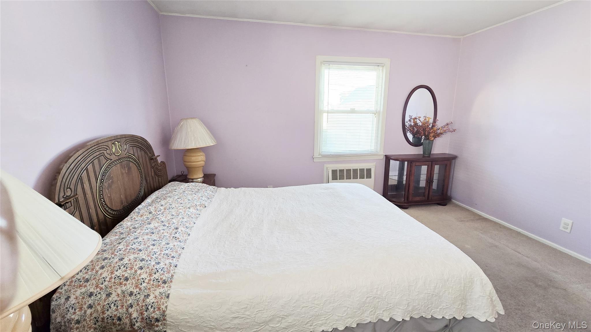 154-07 24th Road Queens, NY 11357 - Photo 11 of 16 a bedroom with a bed and a sink