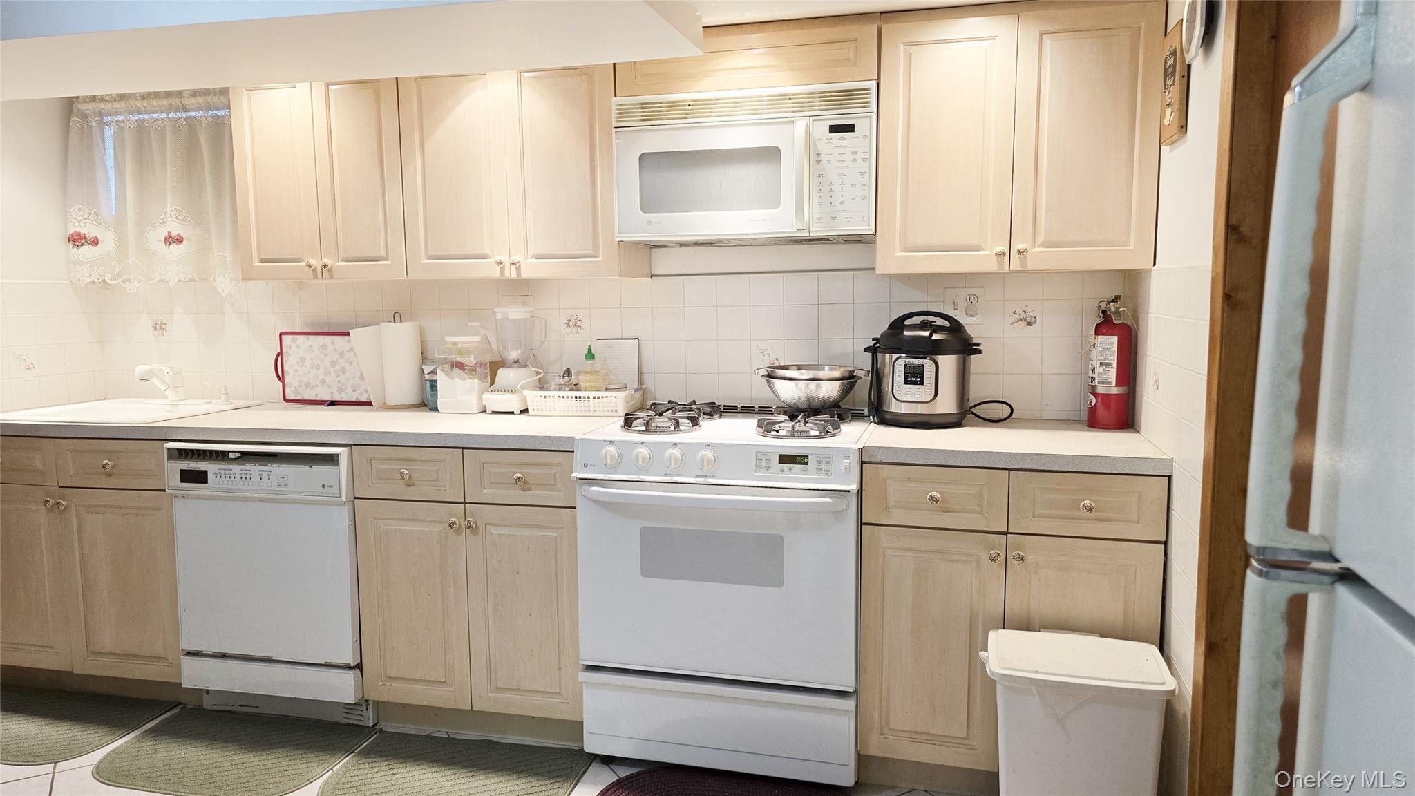 154-07 24th Road Queens, NY 11357 - Photo 14 of 16 a view of cabinets a washer and dryer