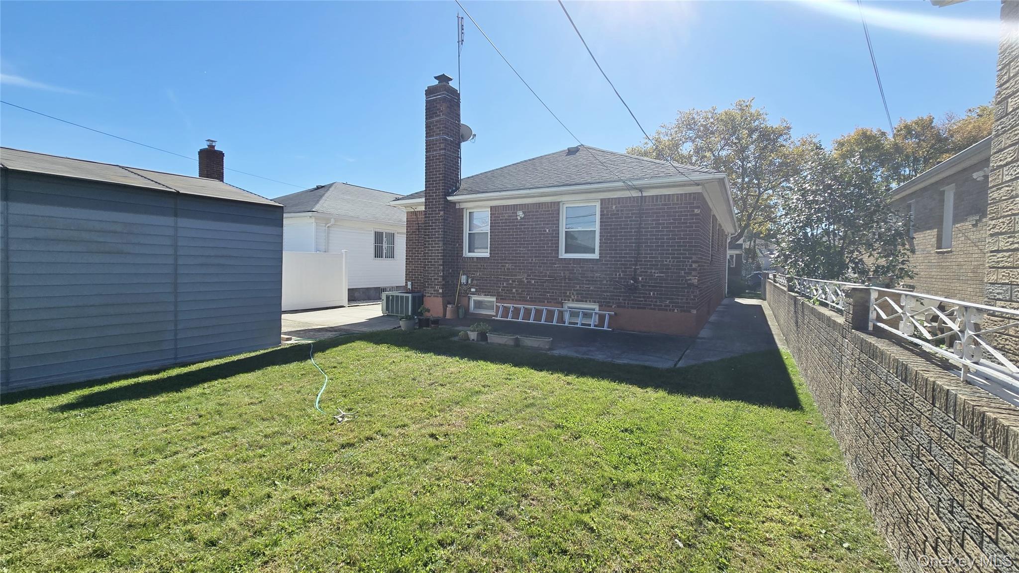 154-07 24th Road Queens, NY 11357 - Photo 15 of 16 a front view of a house with a yard