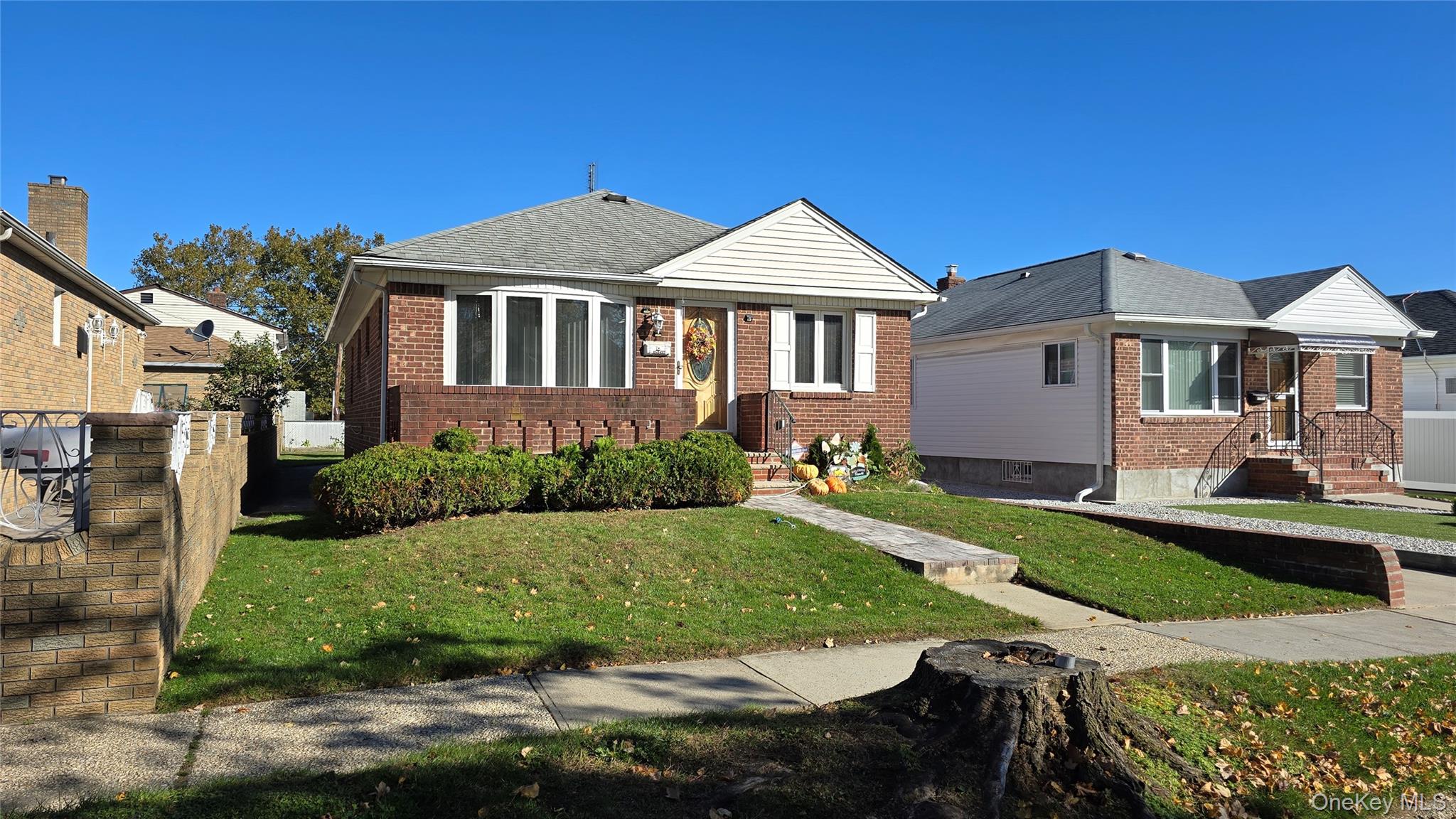 154-07 24th Road Queens, NY 11357 - Photo 2 of 16 a front view of a house with a yard