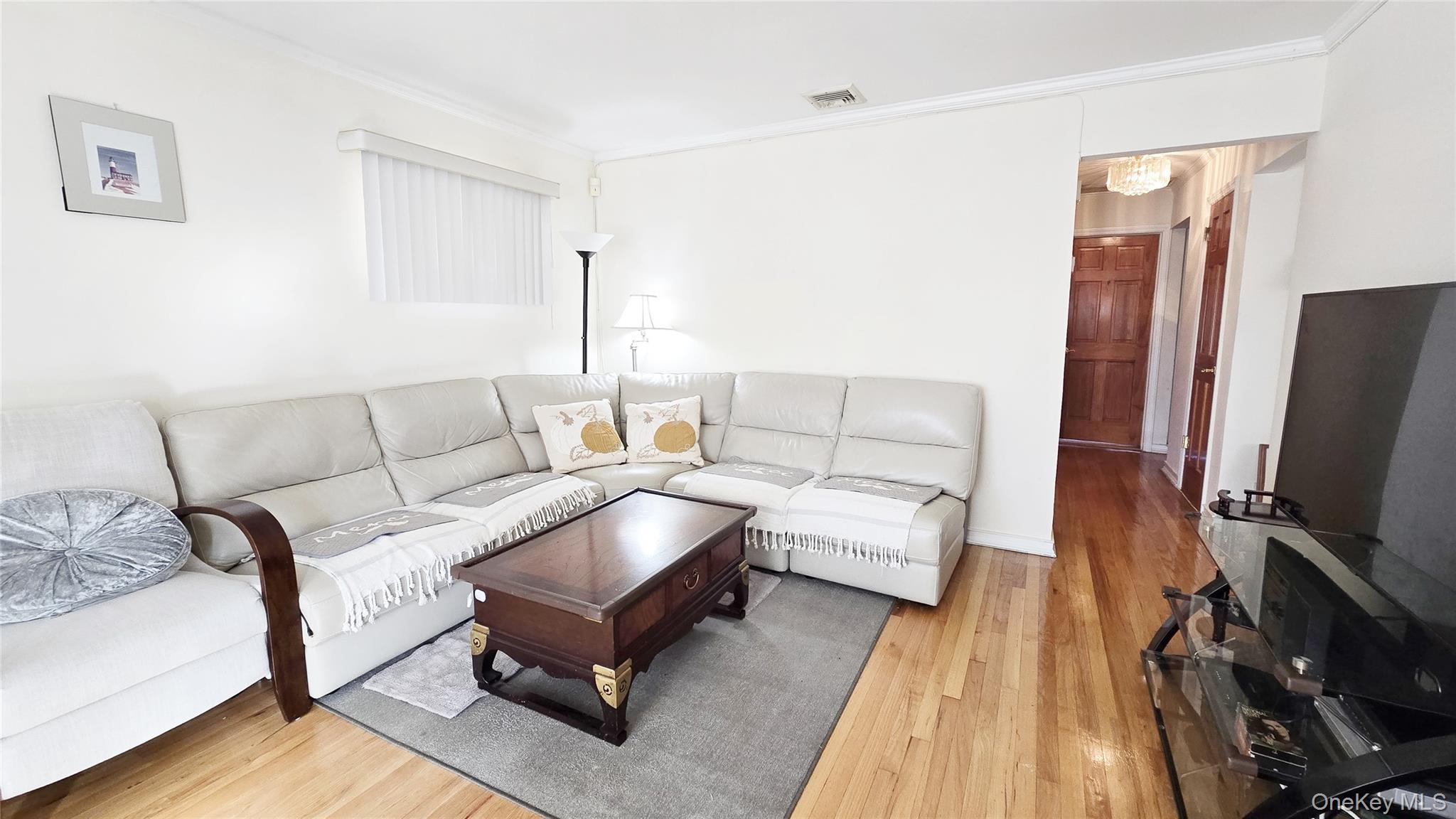 154-07 24th Road Queens, NY 11357 - Photo 7 of 16 a living room with furniture and a flat screen tv