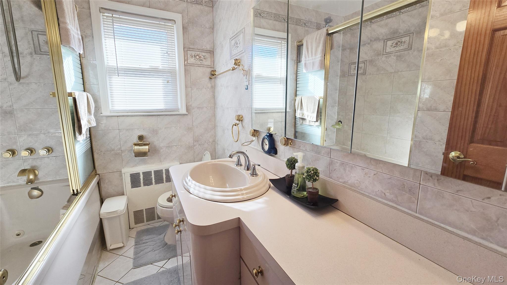 154-07 24th Road Queens, NY 11357 - Photo 9 of 16 a bathroom with a sink a toilet and a shower