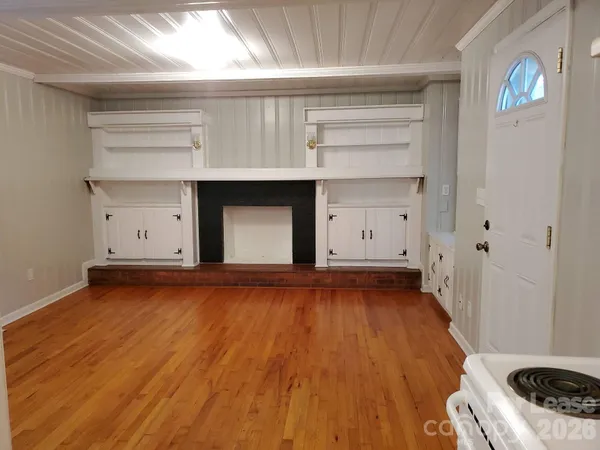 a view of a room with wooden floors and cabinet