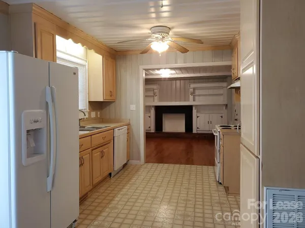 a kitchen with stainless steel appliances a refrigerator and a fireplace