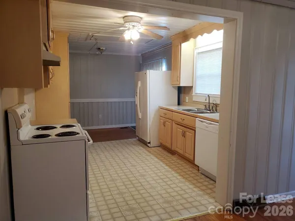 a kitchen with a stove a sink and a refrigerator