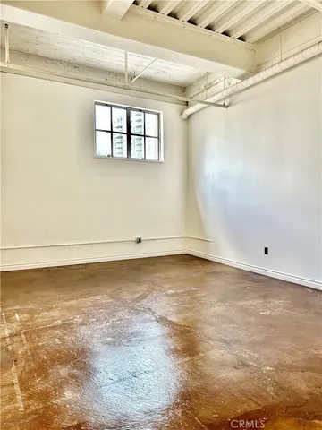 a view of a room with wooden floor and windows