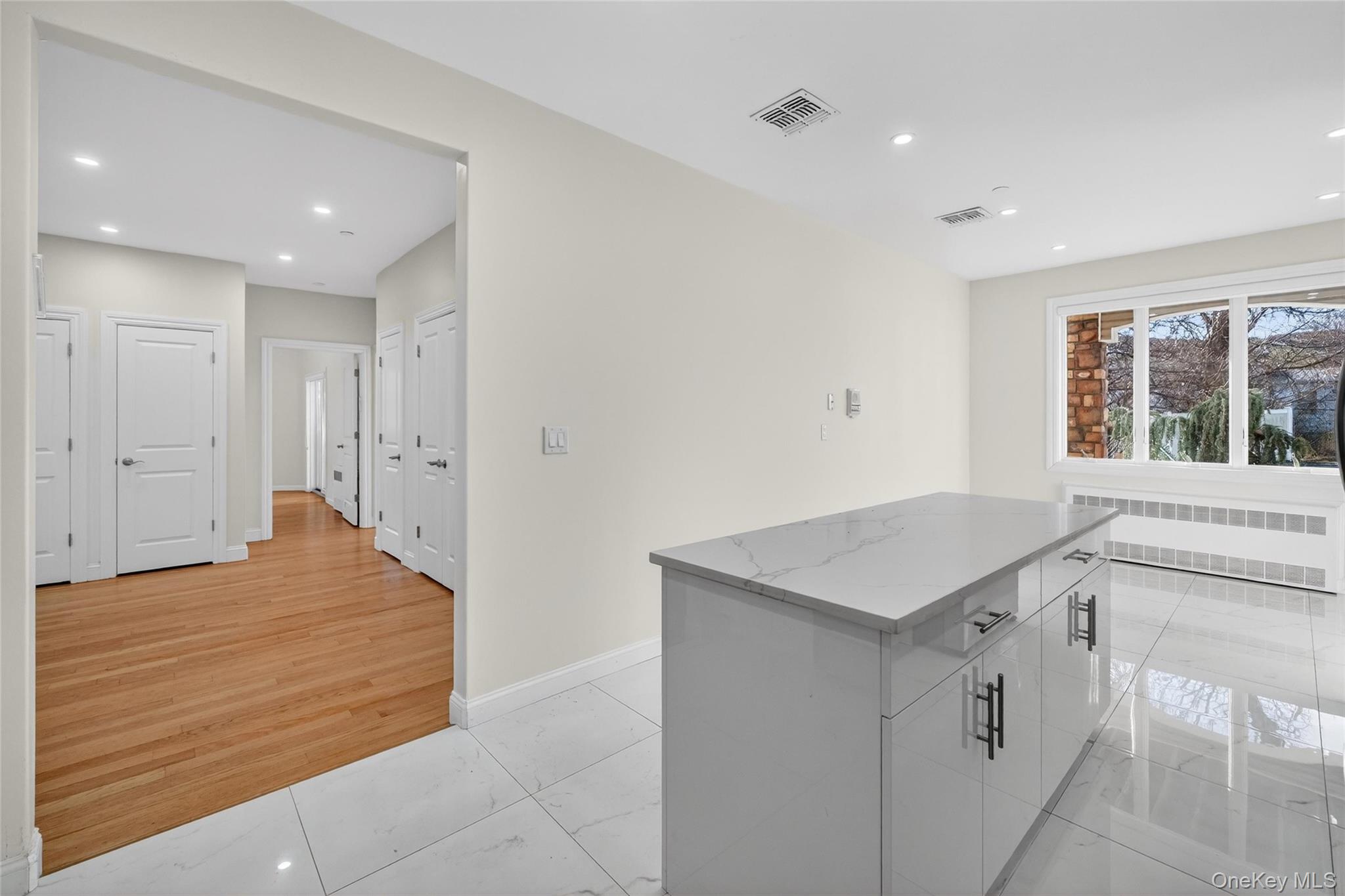 2 Bluefield Drive, Unit 103 Spring Valley, NY 10977 - Photo 11 of 42 a hallway with a sink and a stove