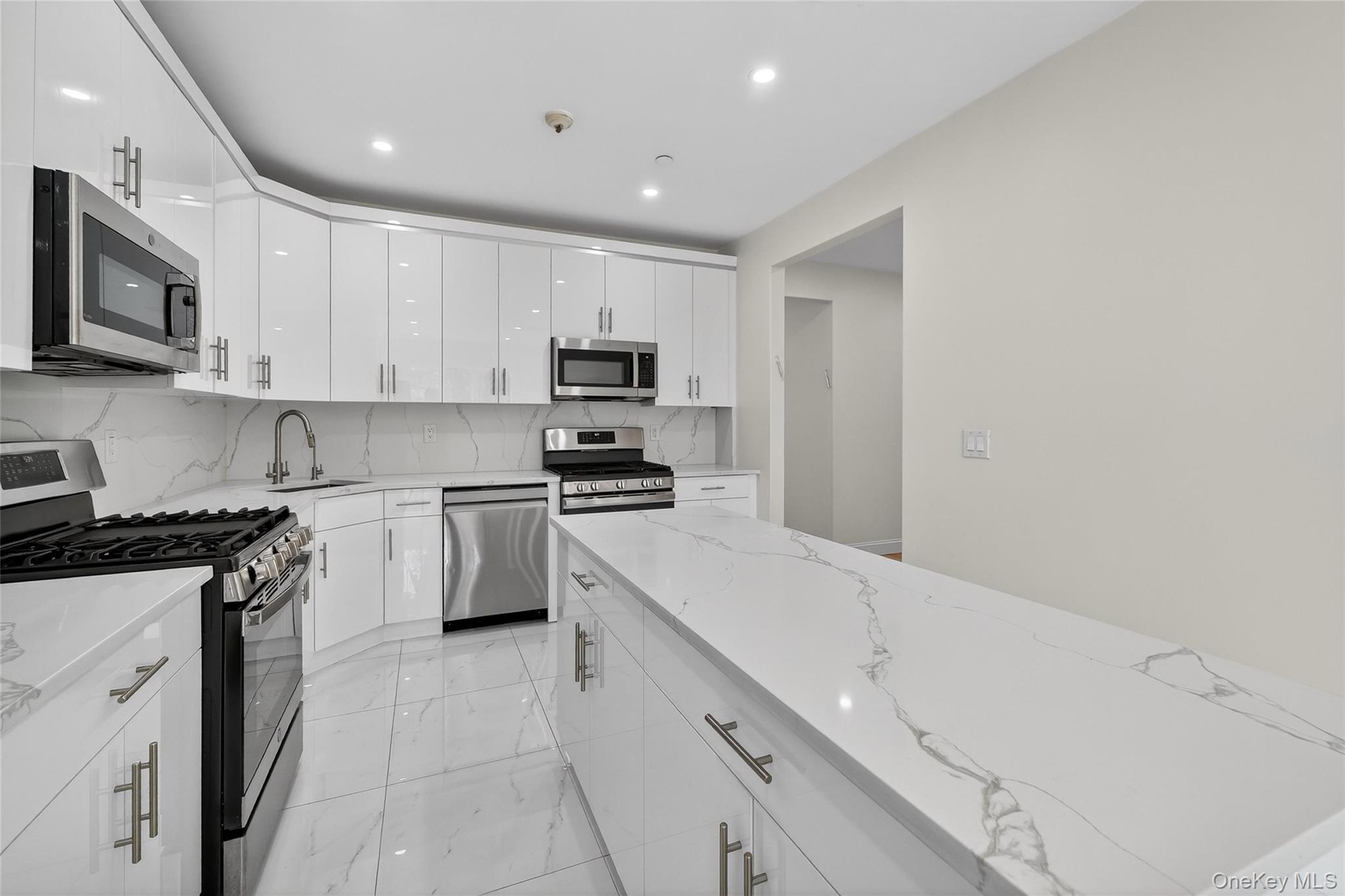 2 Bluefield Drive, Unit 103 Spring Valley, NY 10977 - Photo 12 of 42 a kitchen with a sink a stove and cabinets