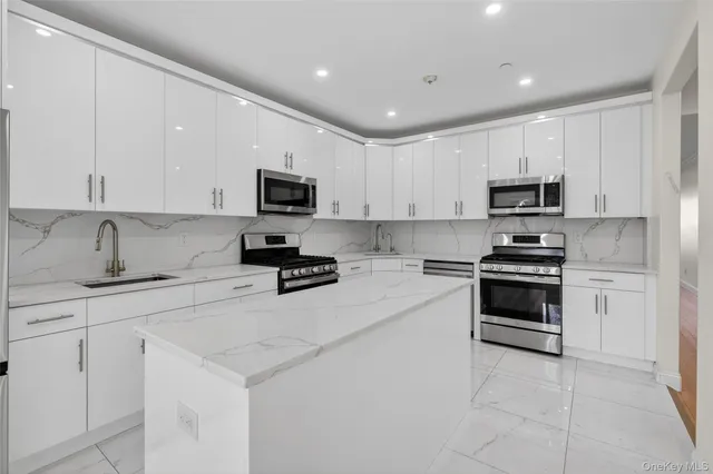 a kitchen with cabinets stainless steel appliances and a counter space