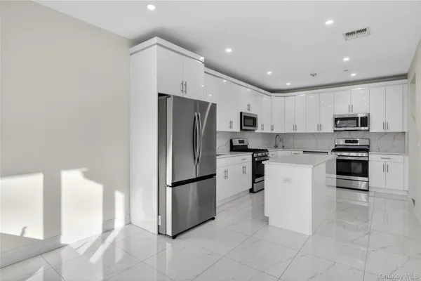 a bathroom with a toilet sink a mirror and shower